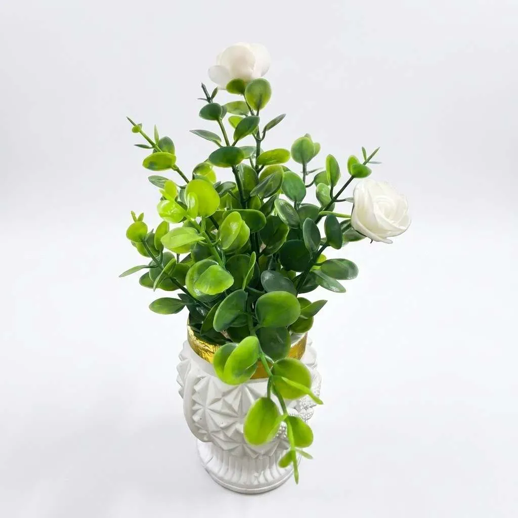 Artificial green plant pot on table