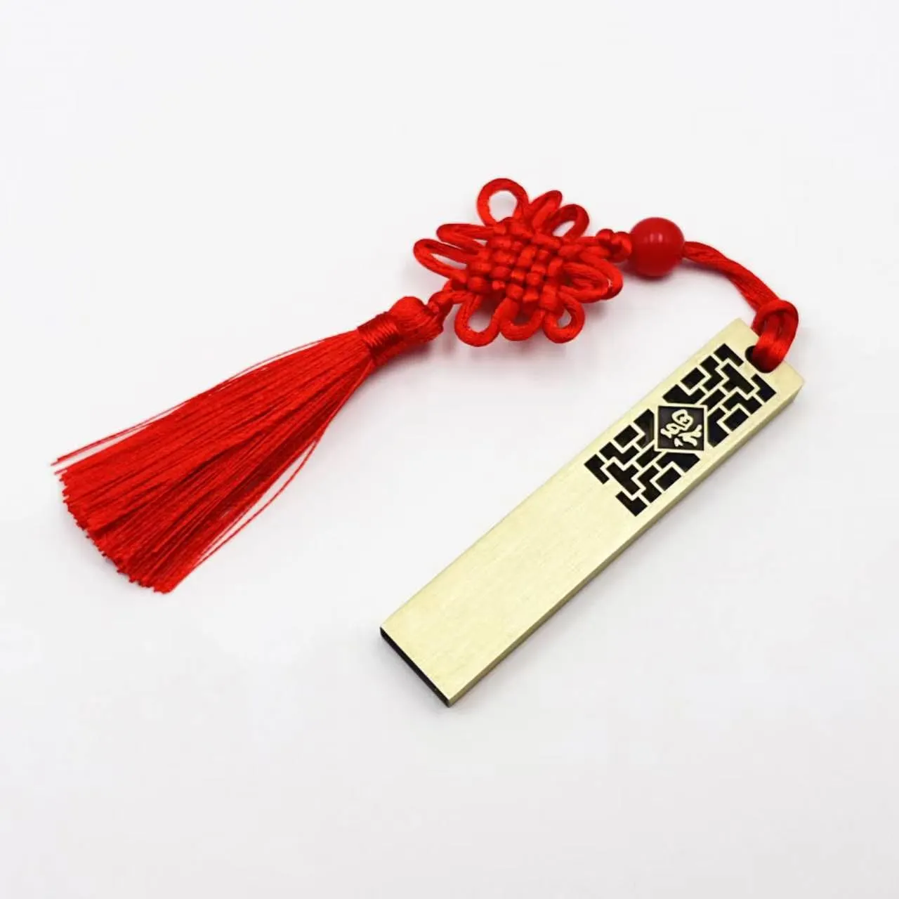 Gold USB drive with red tassel