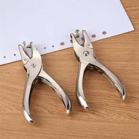 Hand Using Hole Puncher Plier On Paper